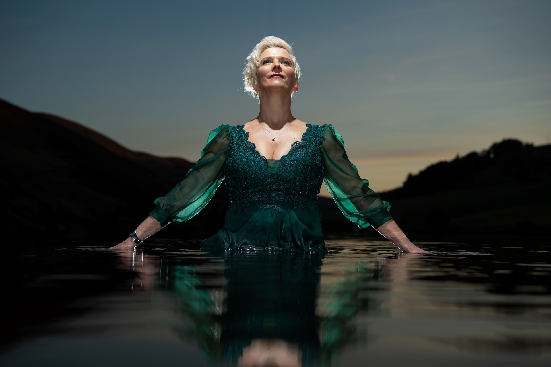 Emma Morwood green dress with hands in water
